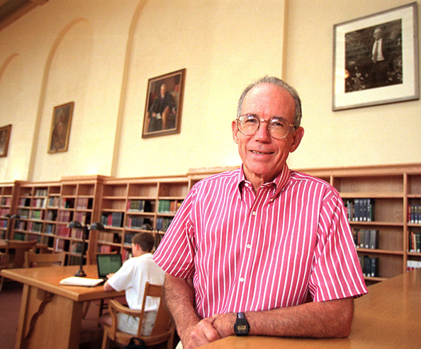 Stanford President Emeritus Donald Kennedy leaning against a table in Green Library