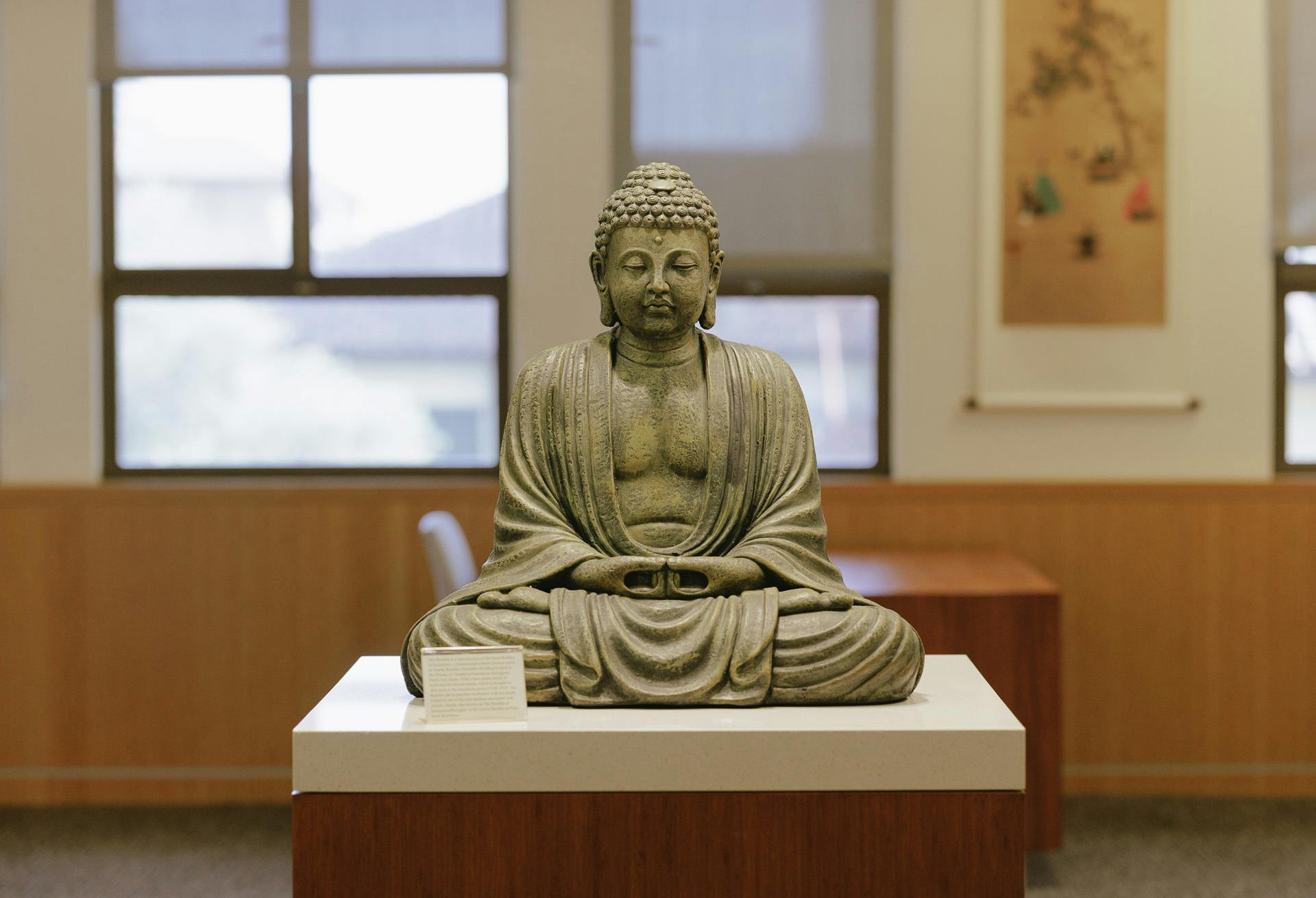 Statue of the Buddha on a platform in the library