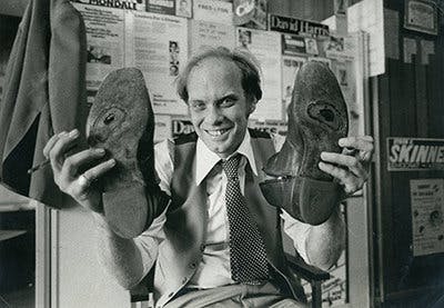 Man holding up shoes
