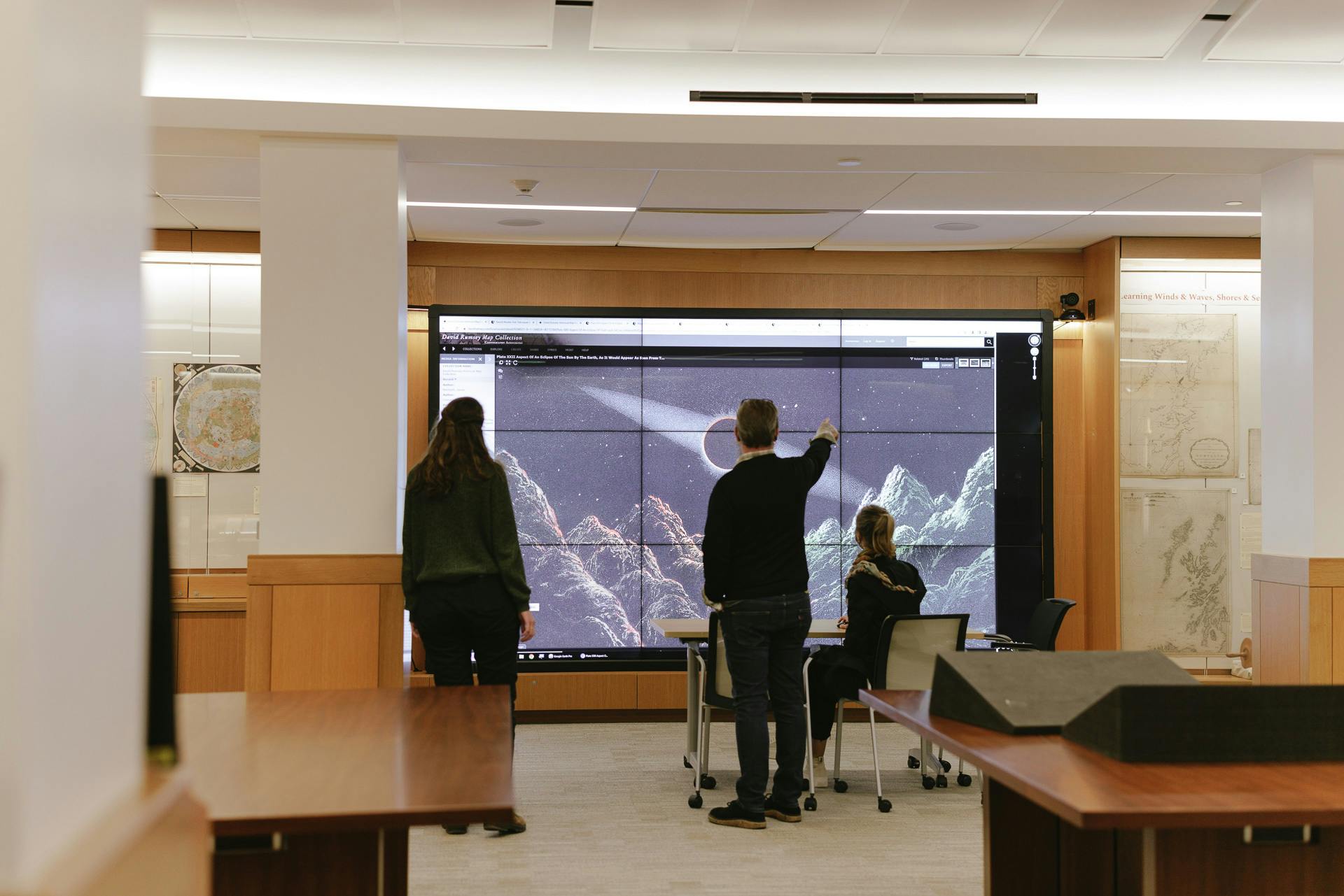 Staff and student using technology wallscreen 