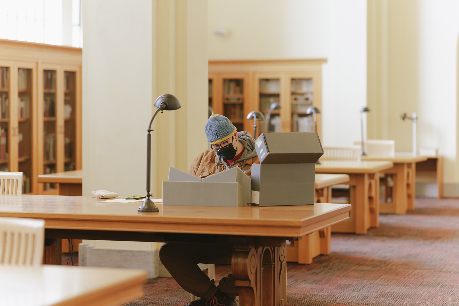 Patron using archival material in Special Collections Reading Room