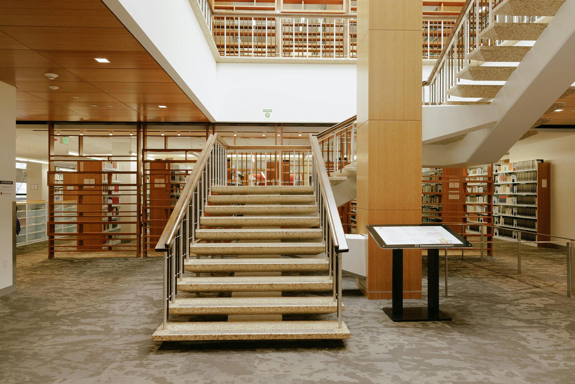 Staircase near books on shelves in stacks