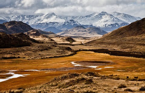 valley landscape with snow-capped mountains in the background