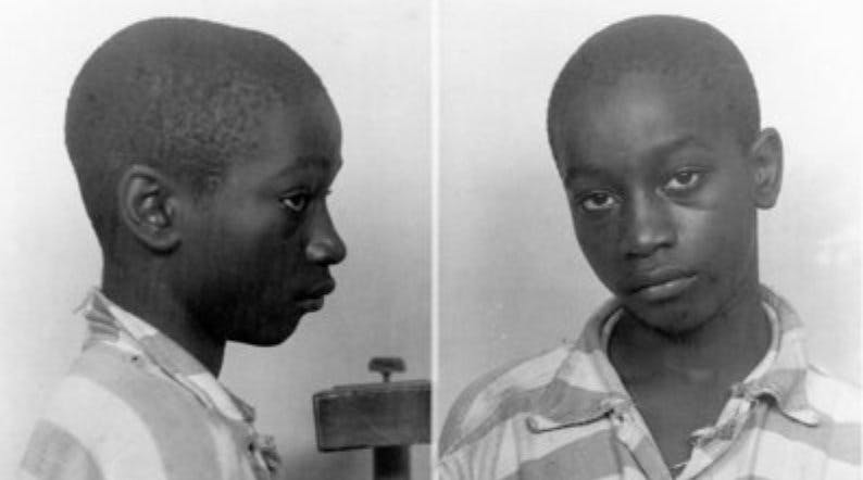 Police mugshot of a young Black boy, first looking right and then looking into the camera.