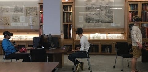 Students sitting at desks and using oculus headsets in the David Rumsey Map Center